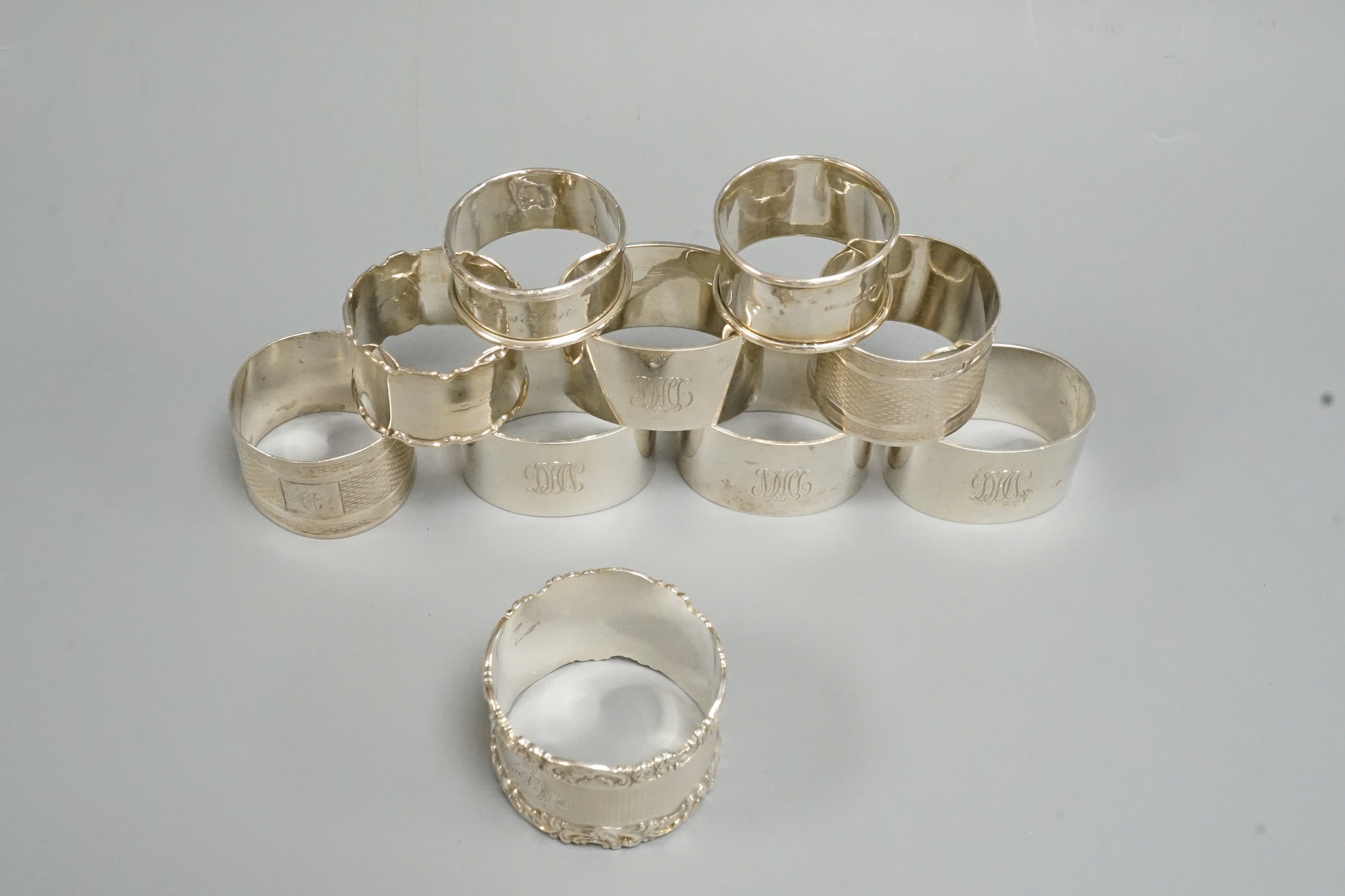 A set of four George V silver oval napkin rings, Mappin & Webb, London, 1925 and six other assorted silver napkin rings.